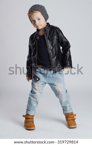 Funny child.fashionable little boy in hat.stylish kid in yellow shoes.winter fashion children