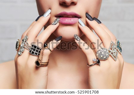 woman's hands with jewelry rings.close-up beauty and fashion portrait. girl make-up and manicure