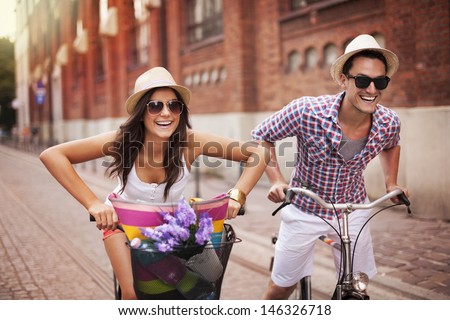 Couple riding bicycles in the city