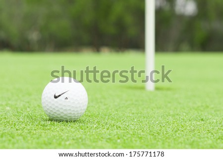 MELBOURNE, AUSTRALIA - JANUARY 18 2014: A Nike golf ball on a green with the hole in the background