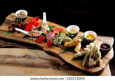 Asian Fusion appetizer plate, with Tempura, Shrimps, Spring rolls and spicy chicken