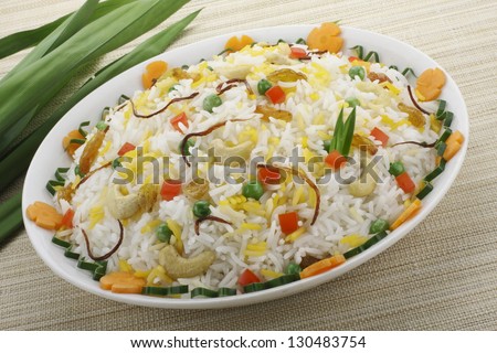 The Indian Pulav- It is a medley of rice, vegetables and/or meat. The rice is browned in oil and then mixed with vegetables, egg, chicken , nuts, fruits etc. Basmati Rice is generally used for making - stock photo