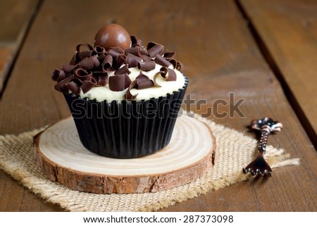 Delicious Chocolate Cupcake On A Wooden Brown Rustic Table Delicious Chocolate Cupcake On A Wooden Brown Rustic Table