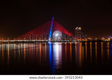 Cityscape of Da Nang city in Vietnam, with night illumination and modern buildings.