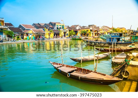 Traditional boats in front of ancient architecture in Hoi An, Vietnam. Hoi An is the World's Cultural heritage site, famous for mixed cultures & architecture.