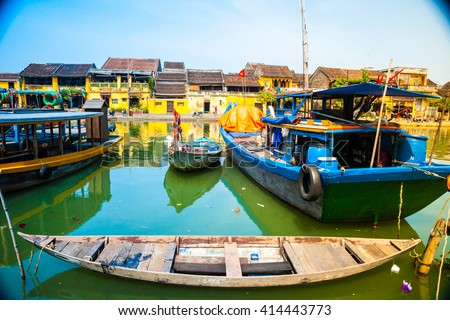 Traditional boats in front of ancient architecture in Hoi An, Vietnam. Hoi An is the World's Cultural heritage site, famous for mixed cultures & architecture.
