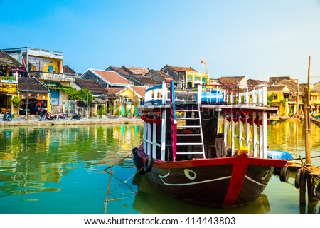 Traditional boats in front of ancient architecture in Hoi An, Vietnam. Hoi An is the World's Cultural heritage site, famous for mixed cultures & architecture.