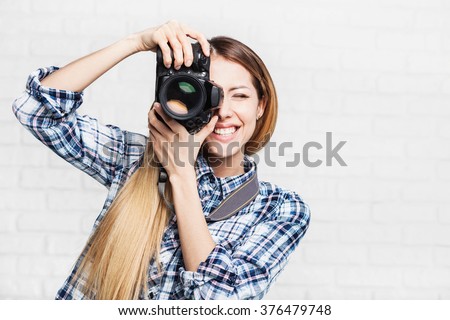 Woman photographer takes images with dslr camera