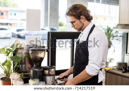 Barista Man Standing For Making Coffee With Attractive Smiling At Shop Owner Barista Man Standing For Making Coffee With Attractive Smiling At Shop Owner