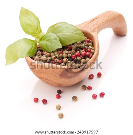 Black peppercorn in a wooden bowl isolated on white