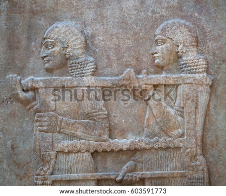 Ancient sumerian stone carving with cuneiform scripting