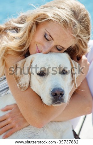 Portrait of young girl hugging her dog