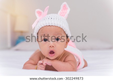 Portrait of cute newborn baby girl on the bed Portrait of cute newborn baby girl on the bed