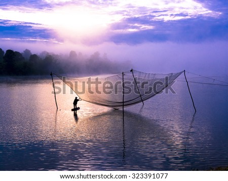 DAK NONG, VIETNAM, APRIL 28. 2013. A view of fisherman beside the lake on lake. DAK NONG, VIETNAM, APRIL 28. 2013.