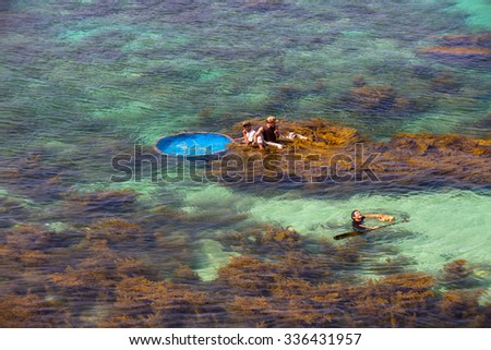 LY SON ISLAND-QUANG NGAI-VIETNAM. APRIL 26,2014. A view of fisher men on round boat in LY SON ISLAND - QUANG NGAI-VIETNAM