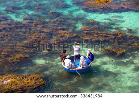 LY SON ISLAND-QUANG NGAI-VIETNAM. APRIL 26,2014. A view of fisher men on round boat in LY SON ISLAND - QUANG NGAI-VIETNAM