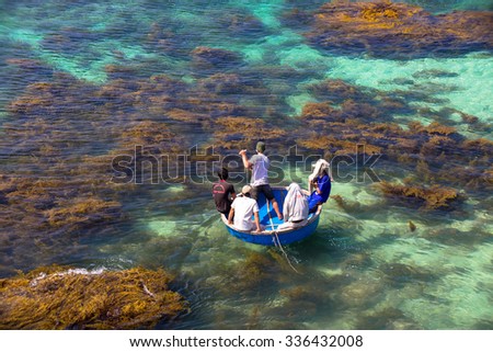 LY SON ISLAND-QUANG NGAI-VIETNAM. APRIL 26,2014. A view of fisher men on round boat in LY SON ISLAND - QUANG NGAI-VIETNAM