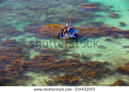 LY SON ISLAND-QUANG NGAI-VIETNAM. APRIL 26,2014. A view of fisher men on round boat in LY SON ISLAND - QUANG NGAI-VIETNAM