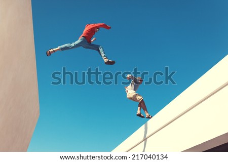 two brave men jumping over the roof, and little motion blur