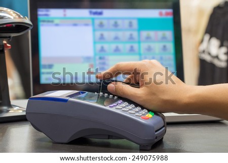 Hand Swiping Credit Card In Store
