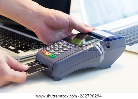 Hand Swiping Credit Card In Store