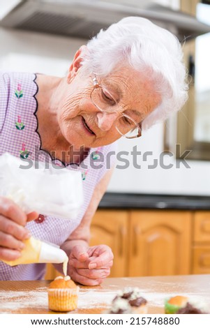 Woman Decorating Cupcakes old woman making decorating cupcakes stock photo 215748850 Woman Decorating Cupcakes old woman making decorating cupcakes stock photo 215748850