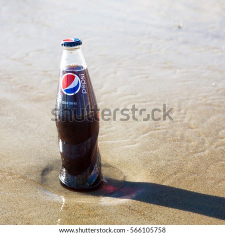 Old Orchard Beach, USA - 3rd Sept 2014: Illustrative editorial image of a bottle of Pepsi being kept cold in the sea. A popular carbonated soft drink produced by PepsiCo since 1893, and sold worldwide