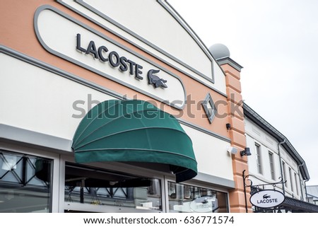 Roermond, Netherlands 07.05.2017 Logo of Lacoste Store in the Mc Arthur Glen Designer Outlet shopping area