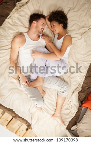 stock-photo-high-angle-view-of-a-happy-couple-lying-in-bed-139170398.jpg