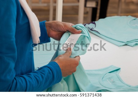 at a garment factory quality control check for defects