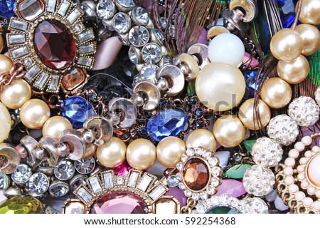 Fashion jewels as background. Jewelery texture. . Necklace earrings bracelet pearls gemstones as background.