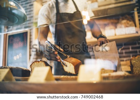 Black man works in pastry shop.