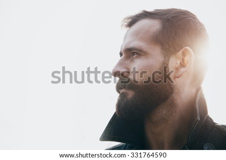 portrait of handsome bearded man in sunlight