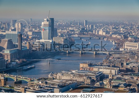 a view of river Thames in London on a sunny day with visible smog, air pollution