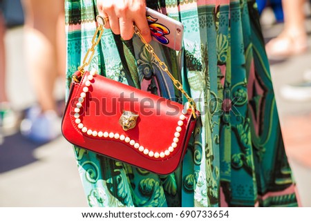 MILAN, JUNE 18, 2017: woman poses for photographers before FERRAGAMO fashion show at Milan Men's Fashion Week street style Spring/Sumer 2018