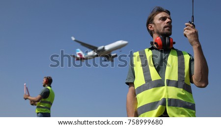 Ground Crew Dialogue with Air Traffic Control Tower Using a Walkie Talkie, Airport Team Activity, Airplane Flying Over Aircrew Controllers, Aircraft Passing Overhead