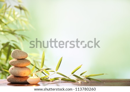 Spa still life with stacked of stone,burning candle and bamboo leaf