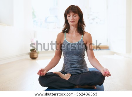 https://thumb1.shutterstock.com/display_pic_with_logo/163108/362436563/stock-photo-portrait-of-fit-mature-woman-in-a-meditative-yoga-pose-at-gym-healthy-female-model-doing-padmasana-362436563.jpg