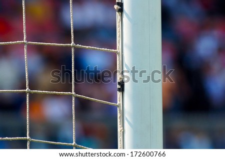 stock-photo-close-up-of-a-soccer-goal-post-in-a-stadium-with-blurry-fans-on-the-background-172600766.jpg