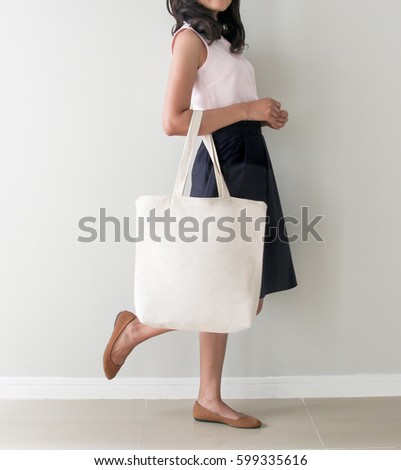 Download Girl Holding Blank Canvas Tote Bag Stock Photo 599335616 ...