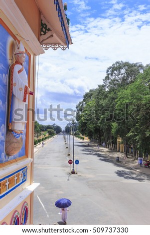 TAY NINH, VIETNAM - October 23, 2016:Cao Dai temple area and meditating followers of the Cao Dai religion in the temple Cao Dai