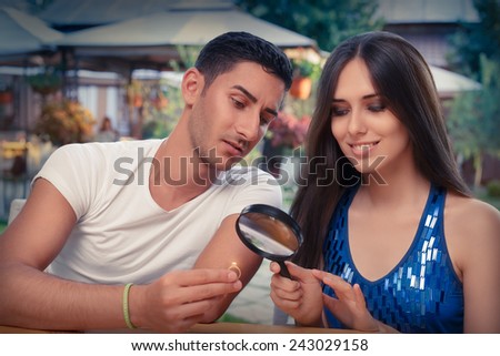 https://thumb1.shutterstock.com/display_pic_with_logo/1649021/243029158/stock-photo-happy-woman-testing-engagement-ring-from-boyfriend-with-magnifier-young-couple-getting-engaged-in-243029158.jpg