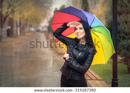 Woman Holding Rainbow Umbrella Checking for Rain  Smiling fall girl 