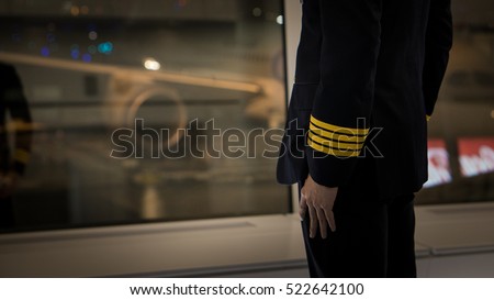 pilot wear four golden strips jacket in airport terminal