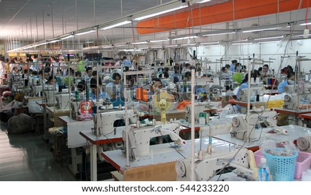 NHA TRANG, VIETNAM - JUNE 04, 2015: Vietnamese workers at the Saga Du Mekong garment factory. The factory specialises in linen, silk, bamboo and fine cotton clothing.