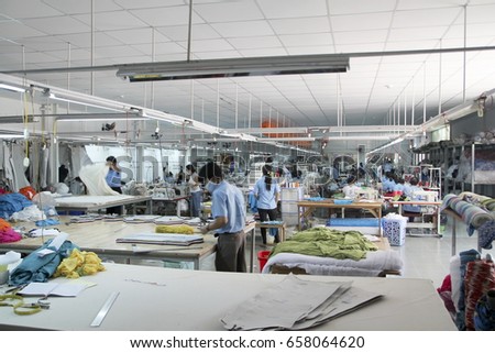 NHA TRANG, VIETNAM - JUNE 04, 2015: A Vietnamese worker at the Saga Du Mekong garment factory. The factory specialises in linen, silk, bamboo and fine cotton clothing.