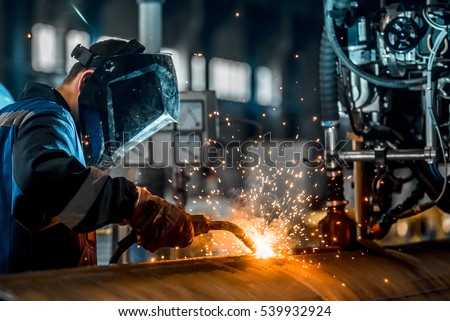 man welds at the factory