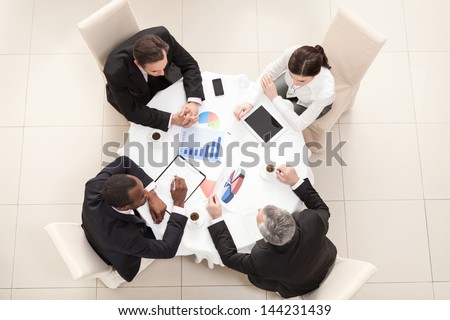 Team Sitting Behind Desk Checking Reports Fotka: 144231439 - Shutterstock