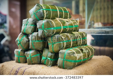 Street food stall selling traditional New Year's holiday Banh Tet wraps on the street of Nha Trang, Vietnam.