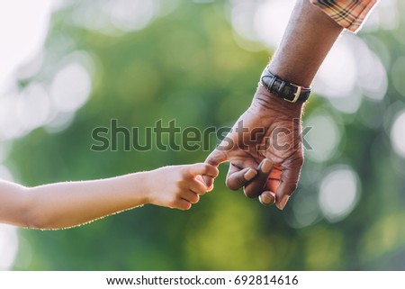 stock-photo-cropped-view-of-african-american-grandfather-holding-hands-with-little-granddaughter-692814616.jpg